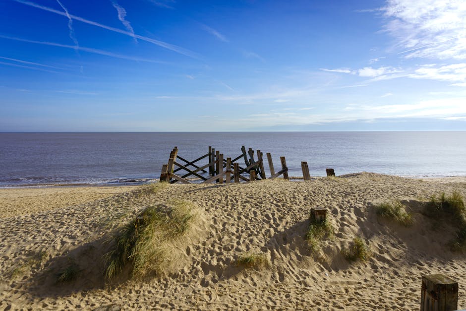 Beautiful beach landscape in Great Yarmouth with old wooden structure and clear skies.