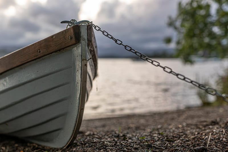 A rowboat moored on Lake Windermere - the lake's shore at Ambleside